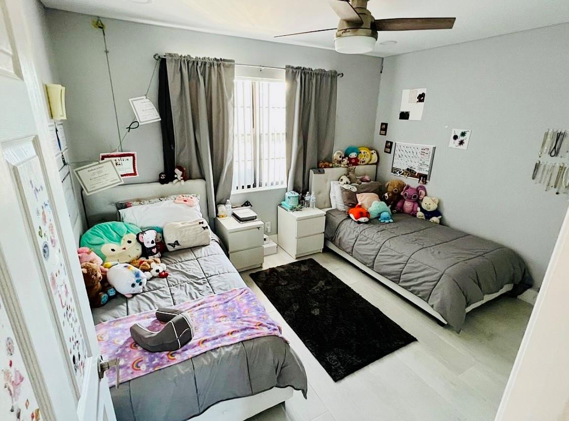 9235 Southwest 8th Street, Unit 207 Boca Raton, FL 33428 - Photo 20 of 24 a bedroom with a bed and a window