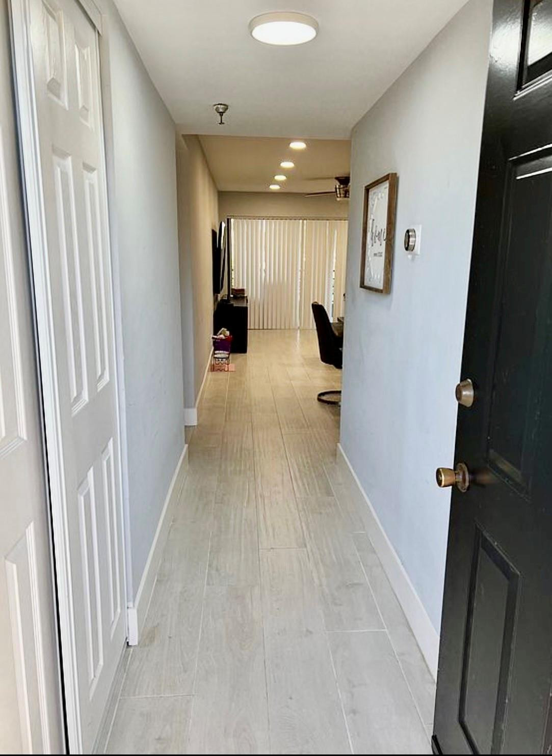 9235 Southwest 8th Street, Unit 207 Boca Raton, FL 33428 - Photo 5 of 24 a view of a hallway with furniture and a window