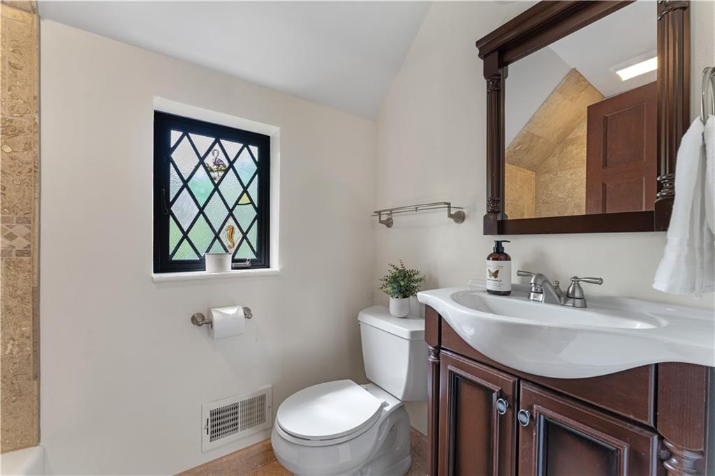 840 Osage Road Pittsburgh, PA 15243 - Photo 31 of 47 a bathroom with a toilet a sink a mirror and a window