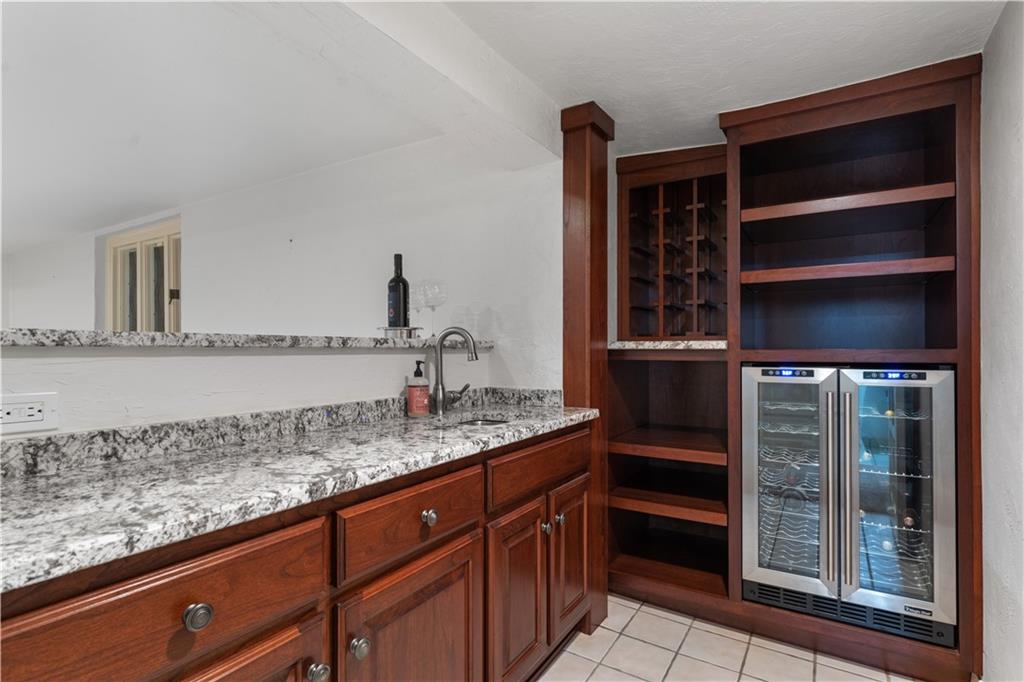 840 Osage Road Pittsburgh, PA 15243 - Photo 33 of 47 a bathroom with a granite countertop sink and a mirror