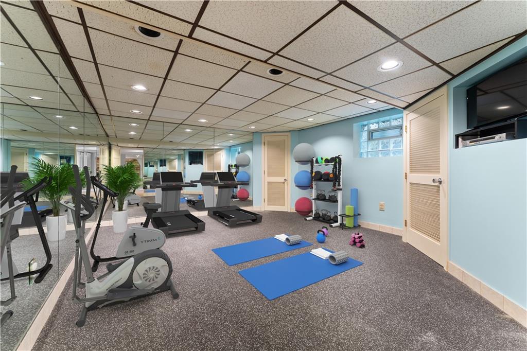 840 Osage Road Pittsburgh, PA 15243 - Photo 35 of 47 a room with gym equipment and a flat screen tv