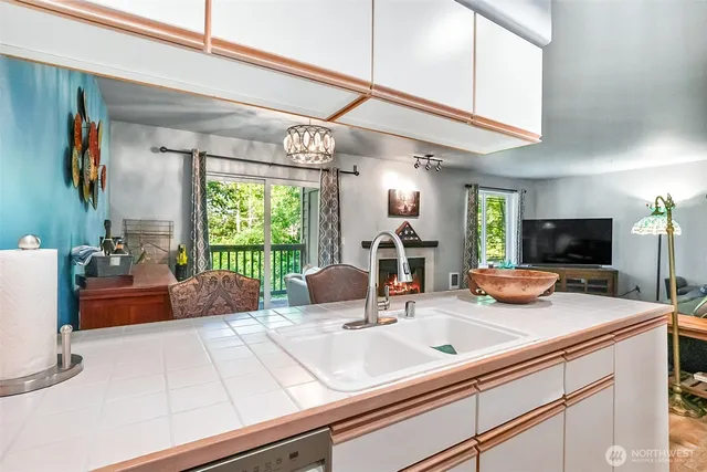a kitchen with a sink and a large window