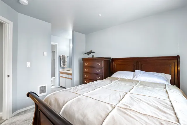 a bedroom with a bed and a dresser