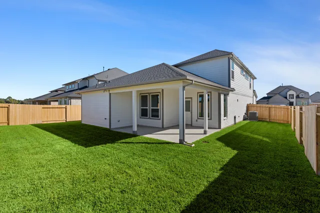 a view of an house with swimming pool and yard