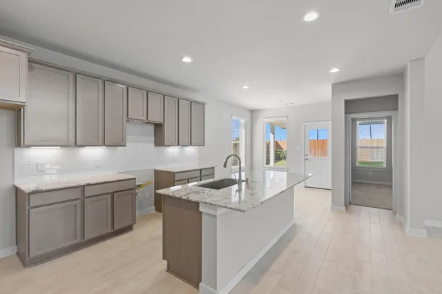 a kitchen with sink cabinets and window