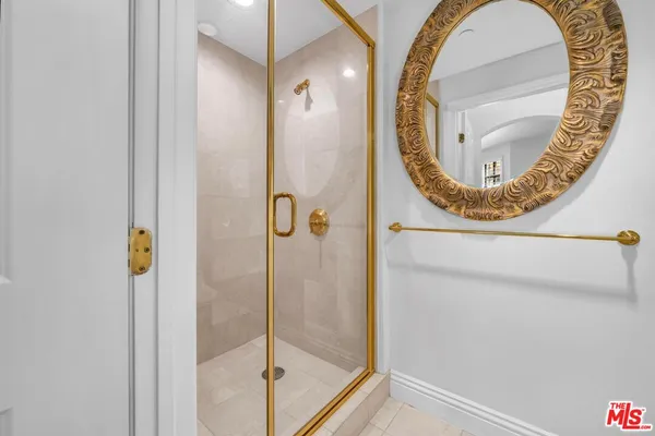 a bathroom with a mirror and a shower
