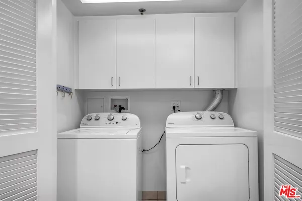 a view of storage and utility room with washer and dryer