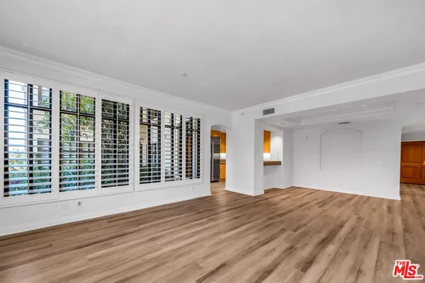 a view of a room with wooden floor and stairs