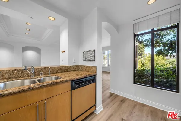 a view of a kitchen counter space and wooden floor