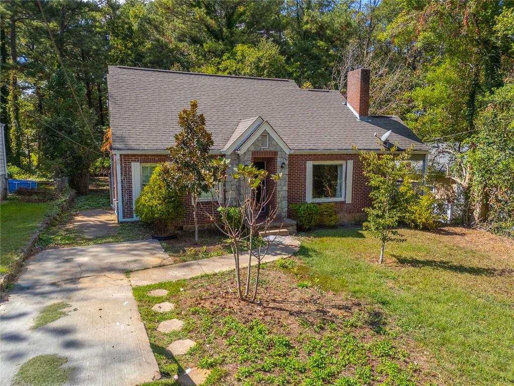 1261 Eastridge Road Southwest Atlanta, GA 30311 - Photo 1 of 36 a house with trees in the background