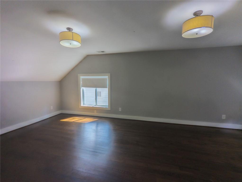 1261 Eastridge Road Southwest Atlanta, GA 30311 - Photo 22 of 36 a view of an empty room with wooden floor and a window