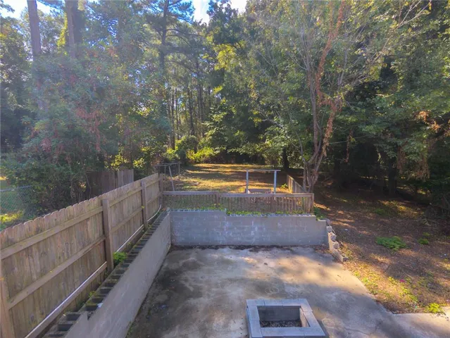 a view of a yard in front of a house with a tree
