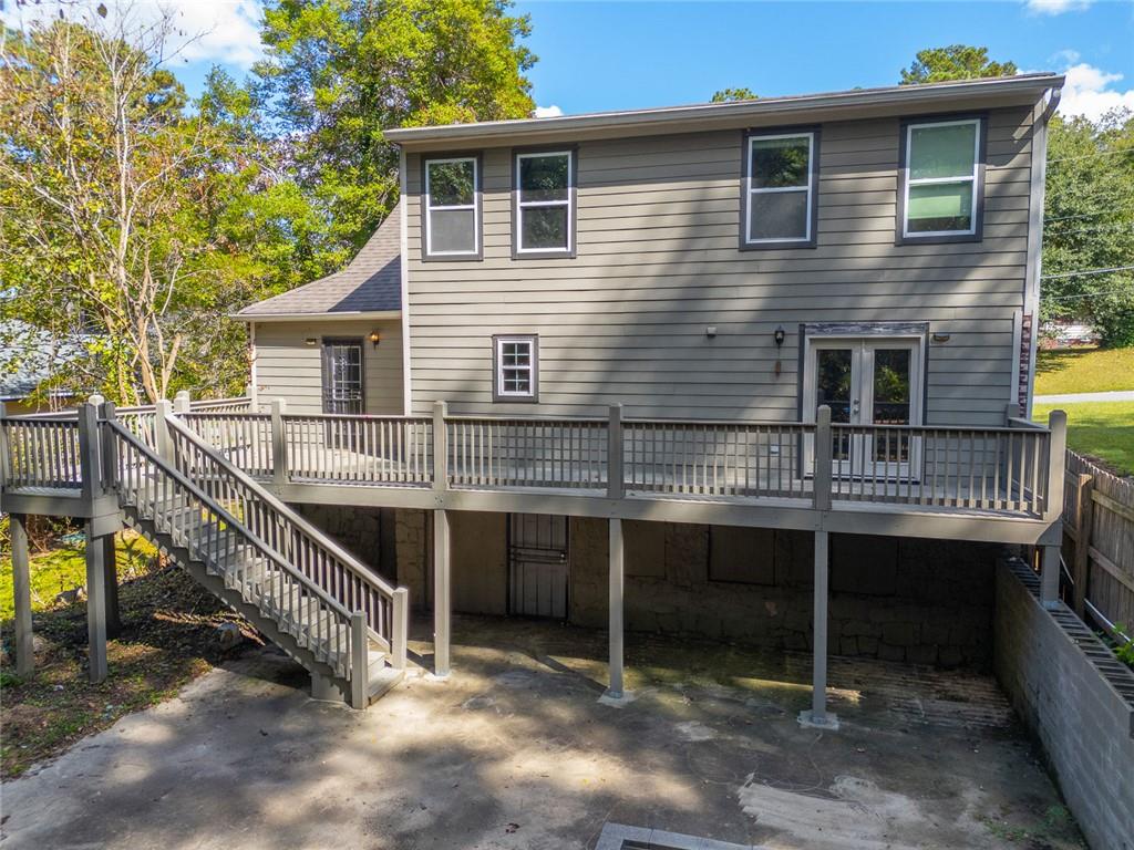 1261 Eastridge Road Southwest Atlanta, GA 30311 - Photo 31 of 36 a balcony with wooden fence and a window