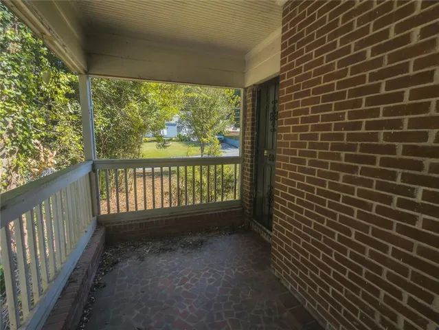 a view of a house with a small yard and wooden fence