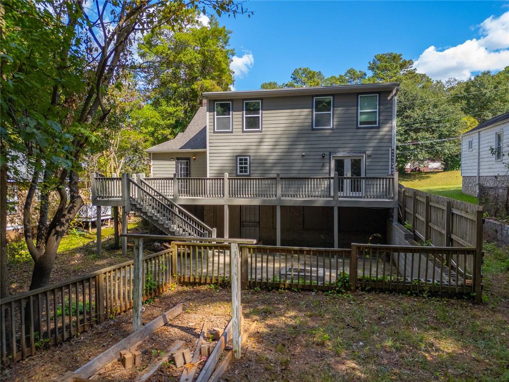 1261 Eastridge Road Southwest Atlanta, GA 30311 - Photo 34 of 36 a view of a house with a small yard and wooden fence