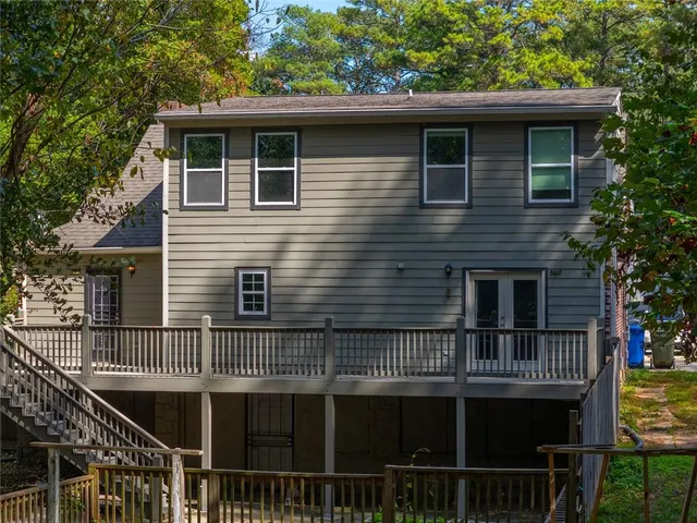 a view of house with roof deck and chair