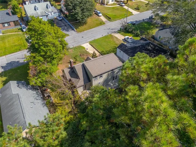 an aerial view of a house with a yard and garden