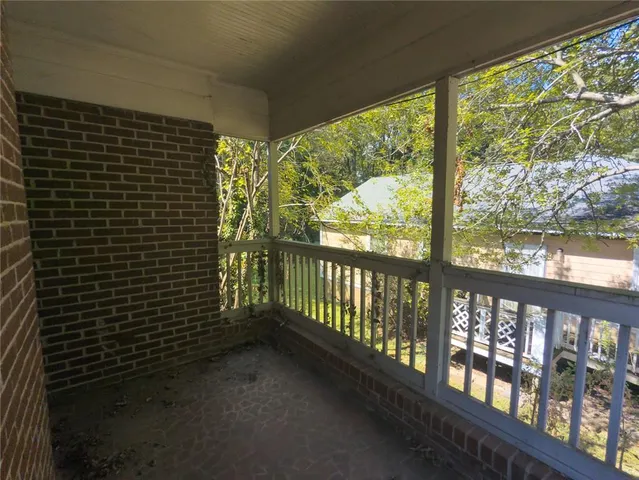 a view of a balcony with wooden floor
