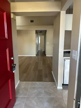 a view of a hallway with wooden floor and staircase