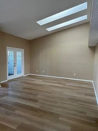 a view of a room with wooden floor