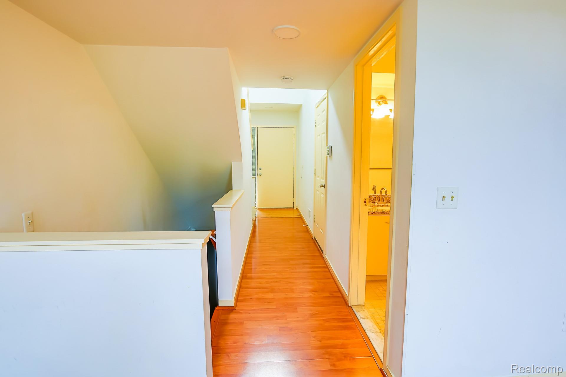 716 Eton Court Rochester, MI 48307 - Photo 23 of 41 Wood-finish flooring throughout, white painted walls, and an overhead lighting fixture