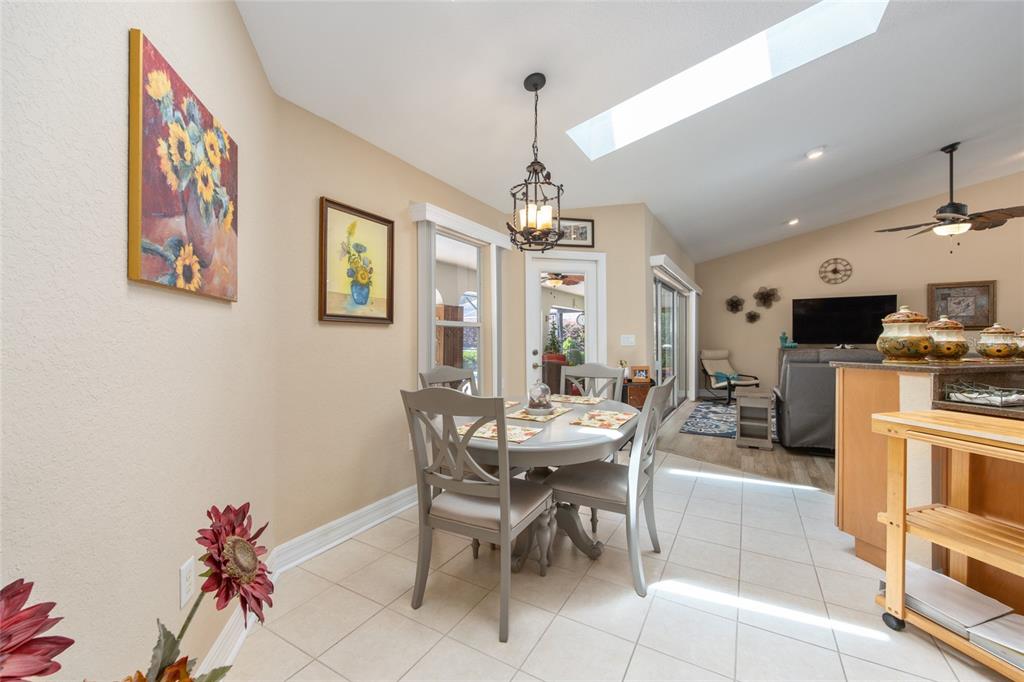 18825 Southwest 93rd Loop Dunnellon, FL 34432 - Photo 28 of 85 a view of a dining room with furniture a kitchen and chandelier