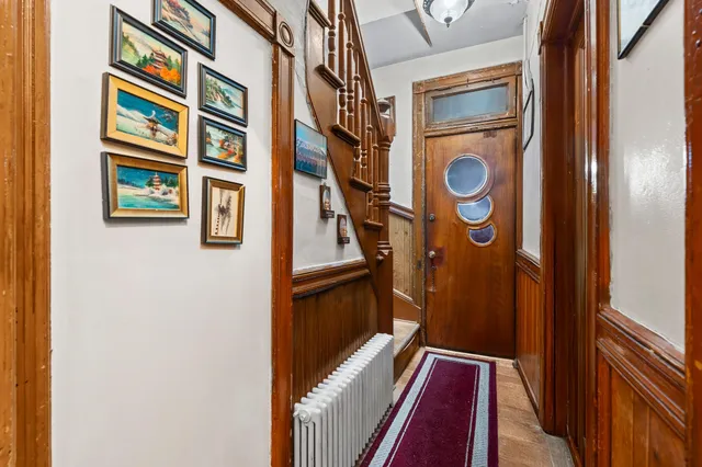 a view of an entryway with wooden floor