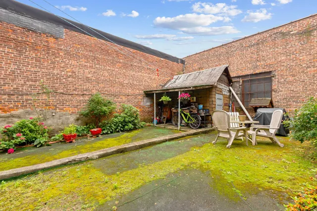 a view of a patio with a table and chairs