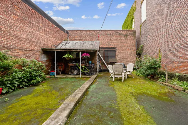 a view of a backyard with a patio and a garden