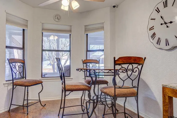 a dining room with furniture a rug and a chandelier