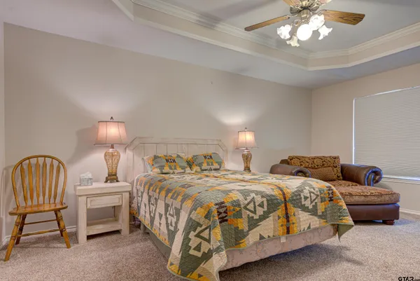 a bedroom with two beds and a chandelier