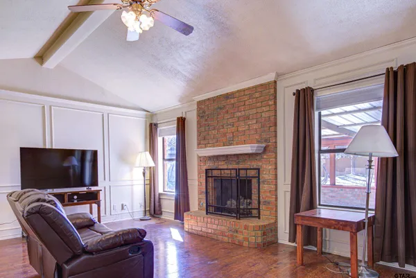 a living room with furniture and a flat screen tv