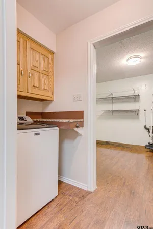 a view of walk in closet with wooden floor