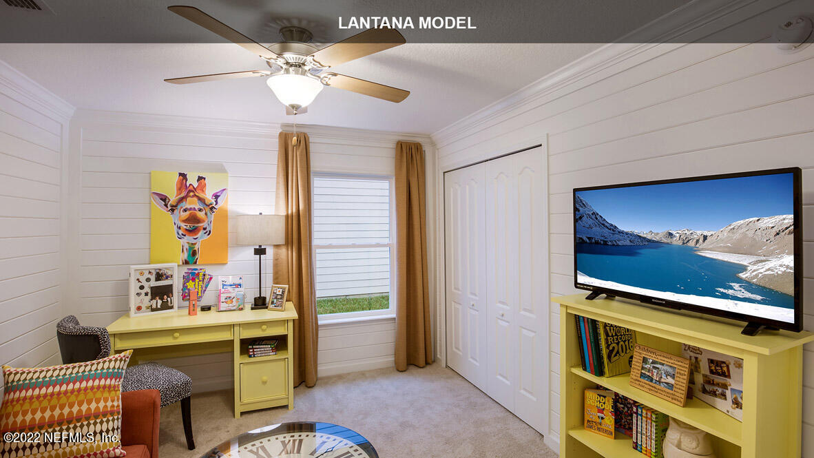 65784 Edgewater Drive Yulee, FL 32097 - Photo 14 of 44 a room with furniture and a flat screen tv