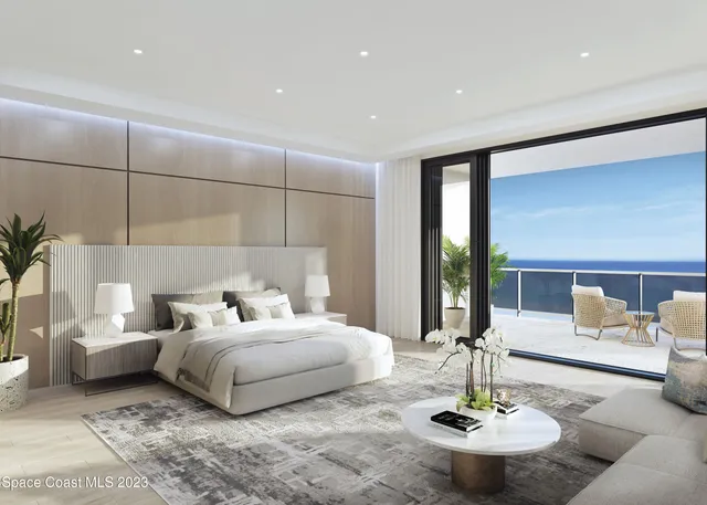 a bedroom with a bed and chandelier