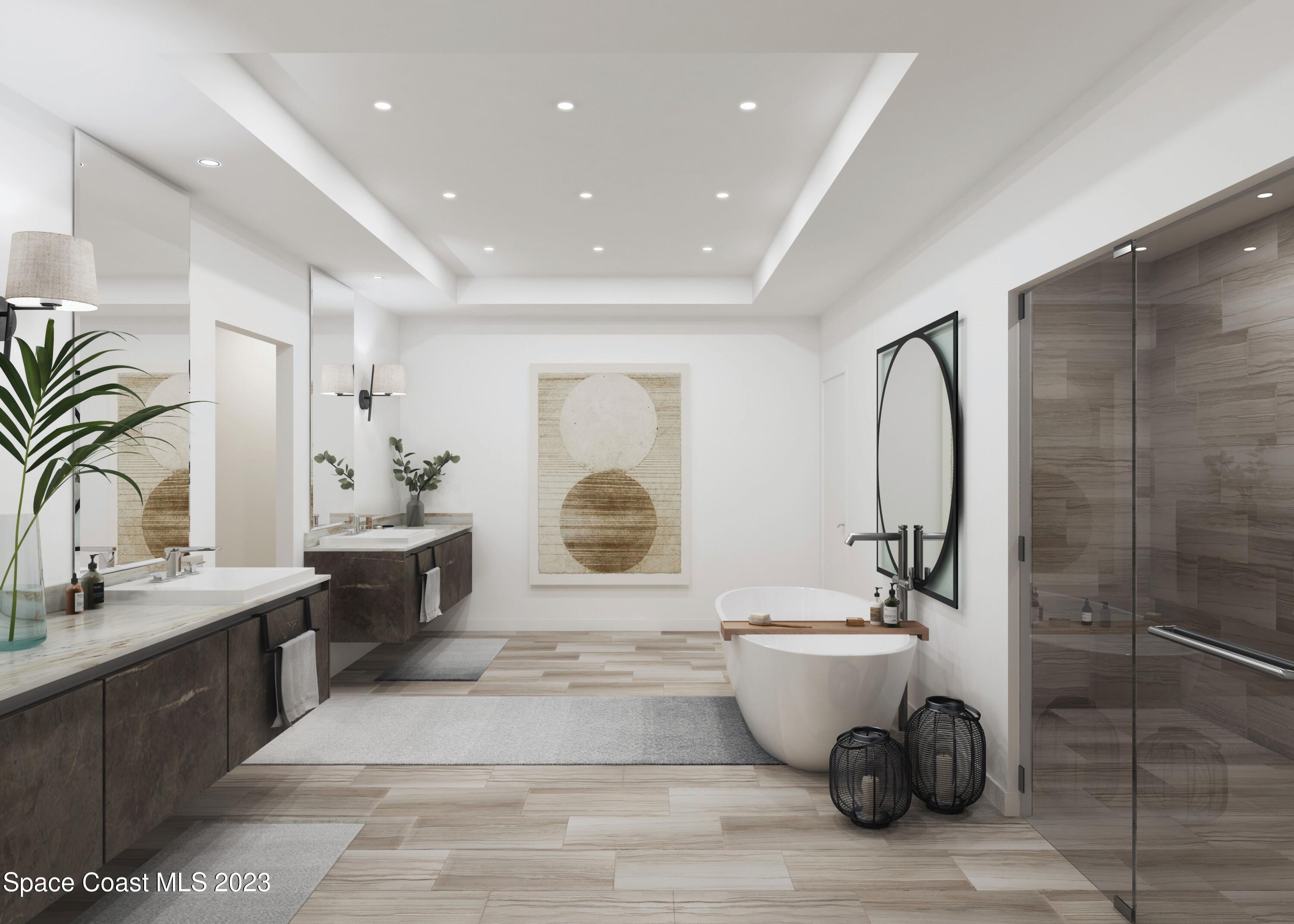 604 Highway A1a Satellite Beach, Unit 803 Satellite Beach, FL 32937 - Photo 8 of 18 a bathroom with a double vanity sink a mirror and a bathtub