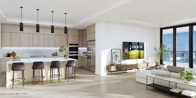 a living room with stainless steel appliances kitchen island granite countertop furniture and a wooden floor