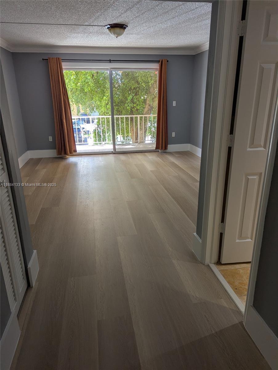 13700 Southwest 62nd Street, Unit 204 Miami, FL 33183 - Photo 16 of 30 an empty room with wooden floor and a window