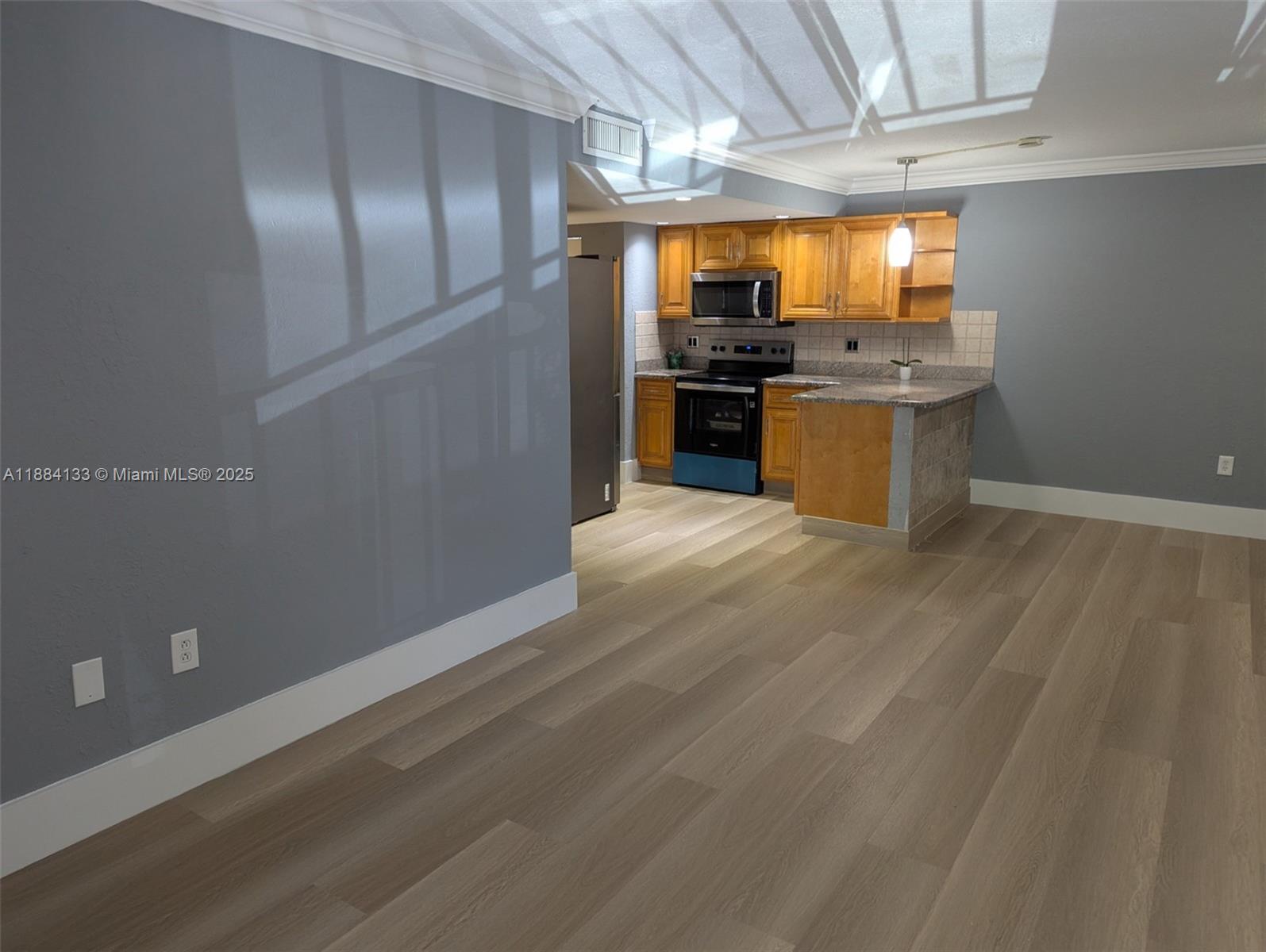 13700 Southwest 62nd Street, Unit 204 Miami, FL 33183 - Photo 2 of 30 a kitchen with stainless steel appliances kitchen island granite countertop a refrigerator a stove and a sink