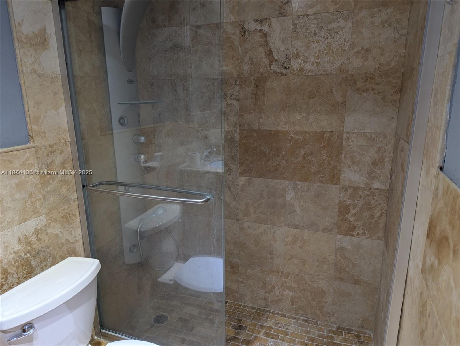 13700 Southwest 62nd Street, Unit 204 Miami, FL 33183 - Photo 21 of 30 a bathroom with a toilet and a shower