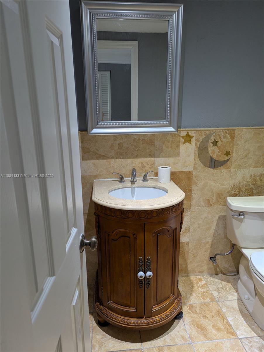 13700 Southwest 62nd Street, Unit 204 Miami, FL 33183 - Photo 23 of 30 a bathroom with a sink and a mirror