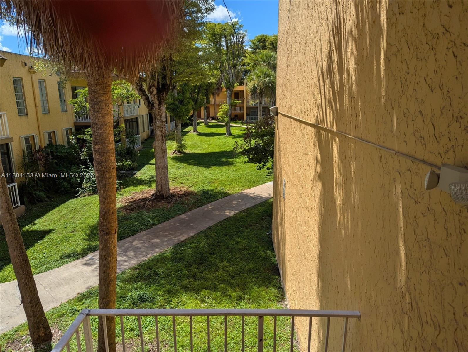 13700 Southwest 62nd Street, Unit 204 Miami, FL 33183 - Photo 27 of 30 a view of a porch with a yard