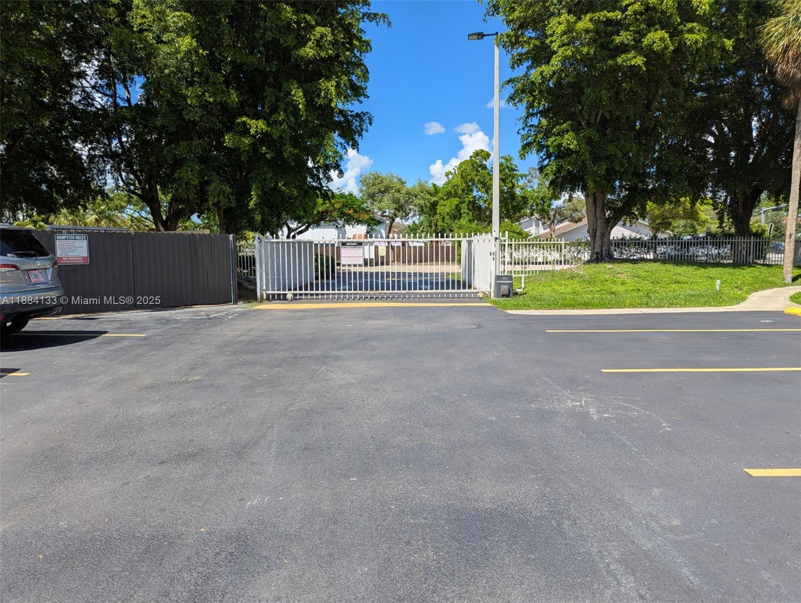 13700 Southwest 62nd Street, Unit 204 Miami, FL 33183 - Photo 30 of 30 a view of a house with a big yard and large trees