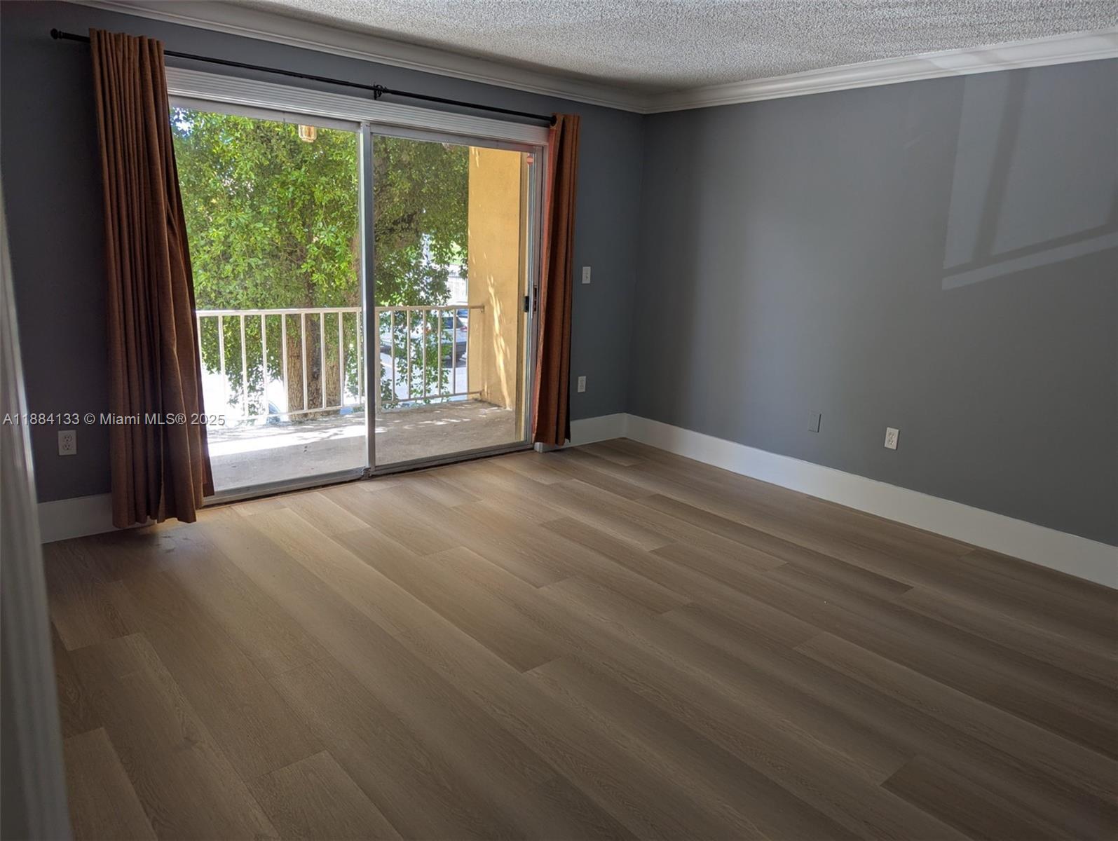 13700 Southwest 62nd Street, Unit 204 Miami, FL 33183 - Photo 3 of 30 a view of a big room with wooden floor and windows