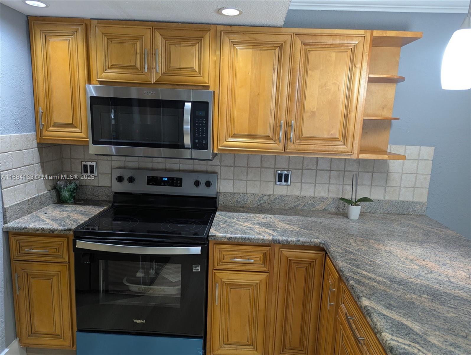 13700 Southwest 62nd Street, Unit 204 Miami, FL 33183 - Photo 7 of 30 a kitchen with granite countertop a sink stove and cabinets