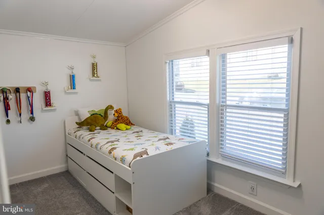 a bed sitting in a bedroom next to a window