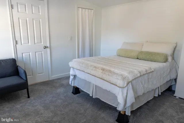 a bedroom with a bed and a chair