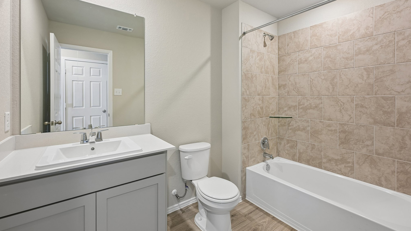 372 Old Stage Coach Road Jarrell, TX 76537 - Photo 20 of 25 Tiled tub surround and a modern vanity create a clean look in this bathroom.