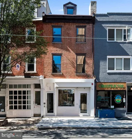 a front view of a house with a street