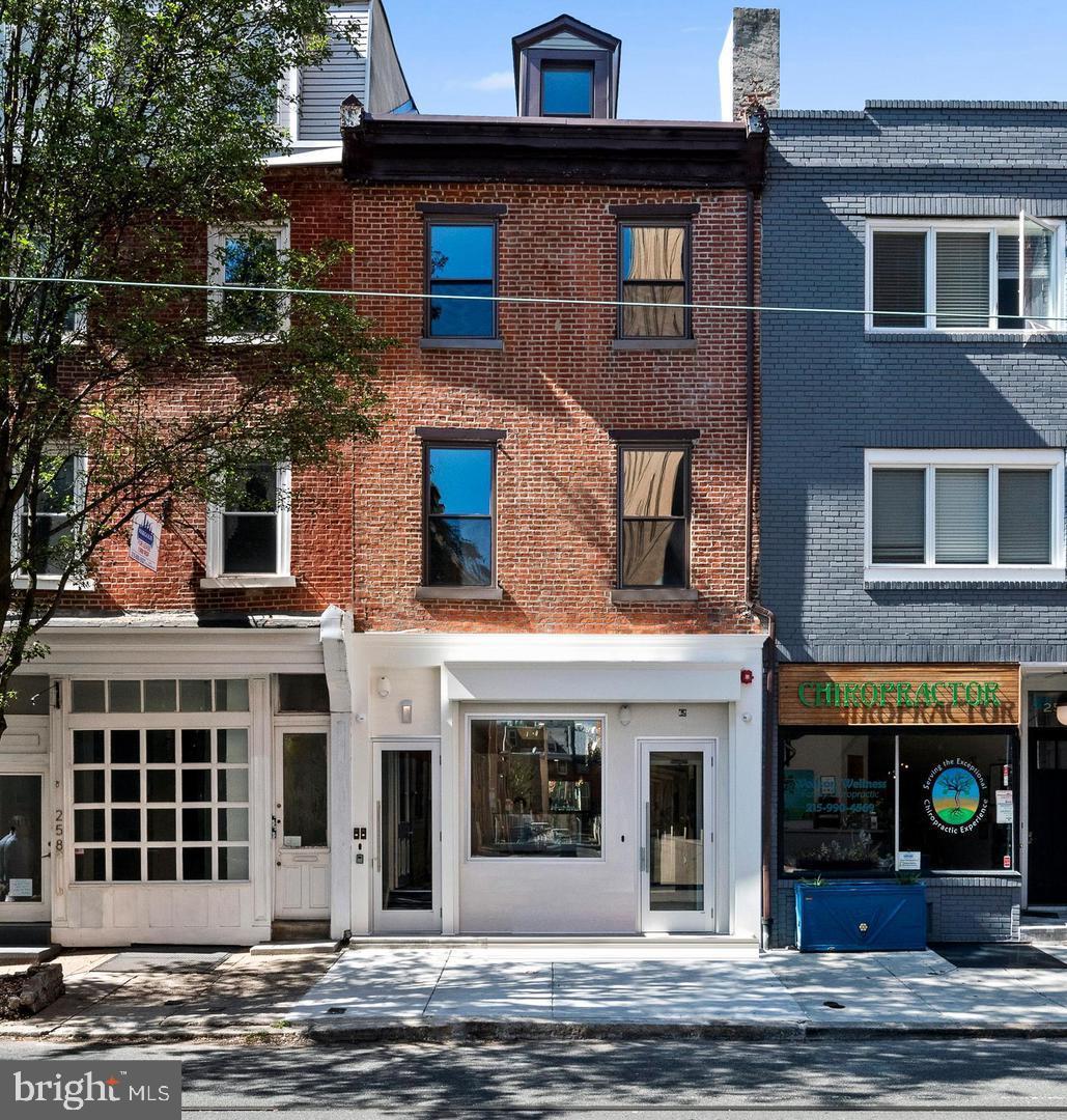 a front view of a house with a street